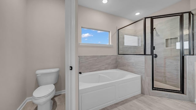 bathroom featuring shower with separate bathtub and toilet