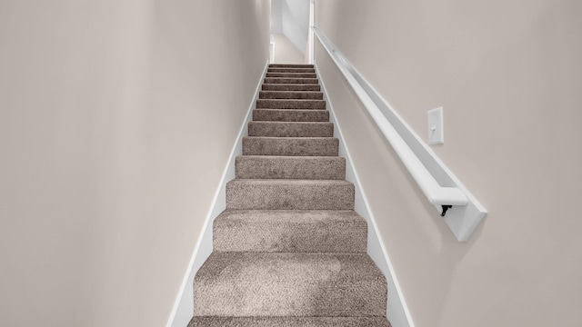 stairs featuring carpet flooring