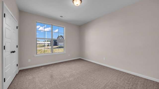 unfurnished room featuring carpet