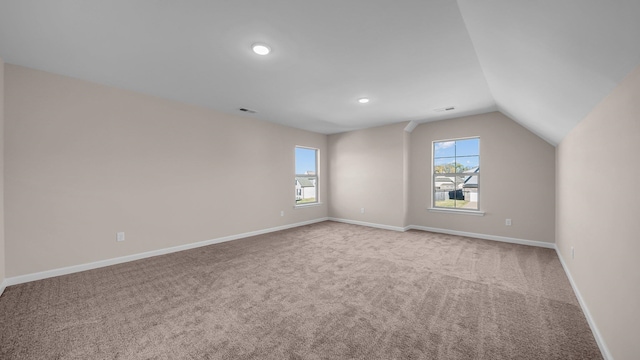 additional living space with carpet flooring and lofted ceiling