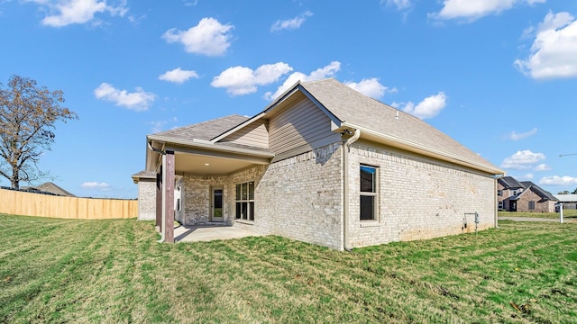 back of house featuring a yard and a patio