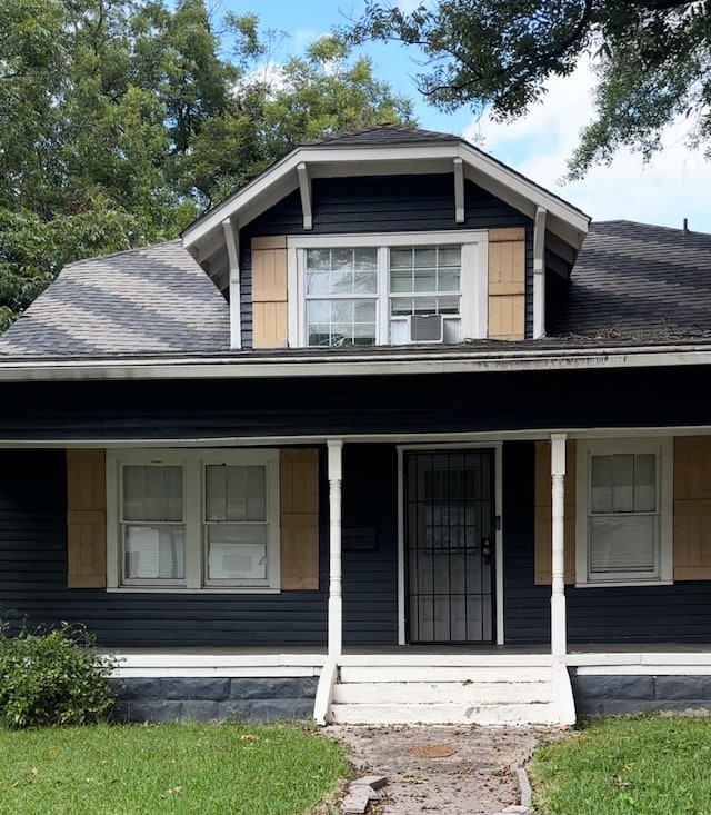 view of front of home featuring cooling unit and a porch