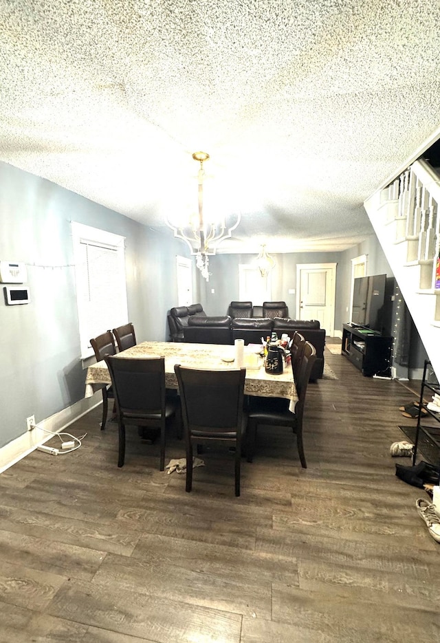 dining room featuring a chandelier, a textured ceiling, and dark hardwood / wood-style flooring