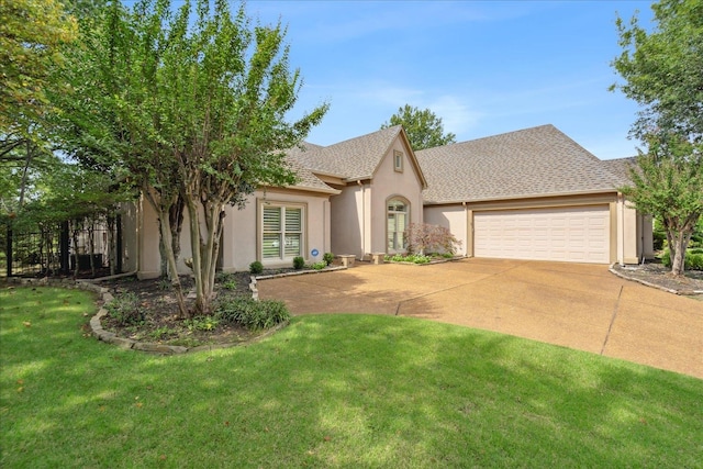 view of front of house featuring a front yard and a garage