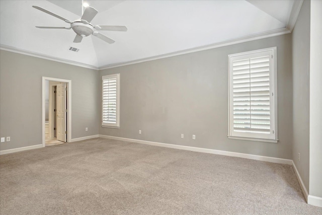 carpeted spare room with ceiling fan, crown molding, and vaulted ceiling