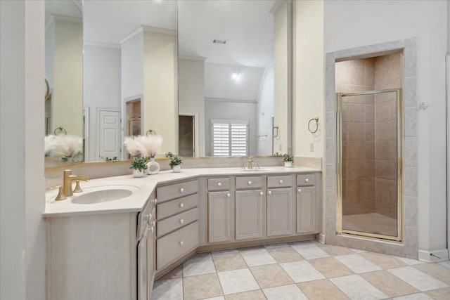 bathroom featuring vaulted ceiling, a shower with shower door, vanity, and crown molding