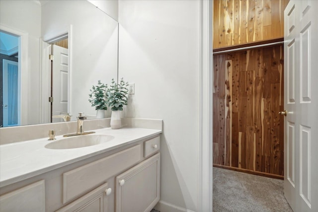 bathroom with wood walls and vanity