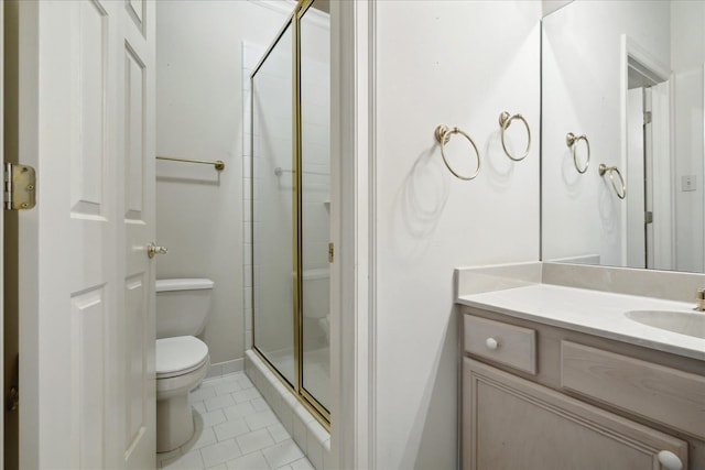 bathroom with tile patterned flooring, vanity, toilet, and a shower with shower door