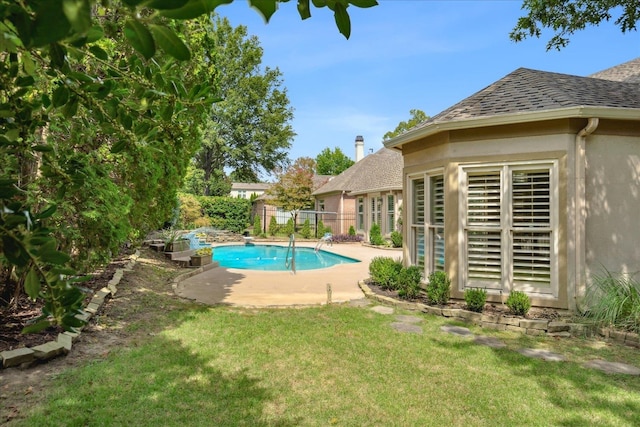 view of pool featuring a yard and a patio