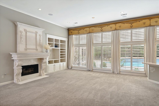 unfurnished living room with a fireplace, ornamental molding, and light carpet