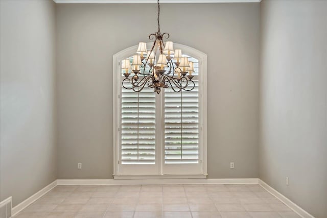 interior space with an inviting chandelier, light tile patterned flooring, and a healthy amount of sunlight