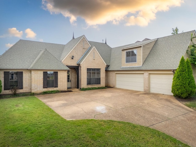 view of front of property with a lawn and a garage