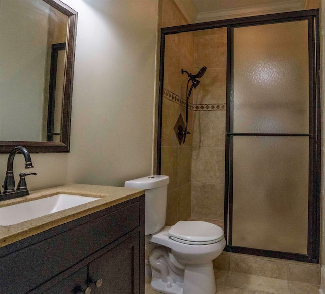 bathroom featuring vanity, toilet, an enclosed shower, and tile patterned floors