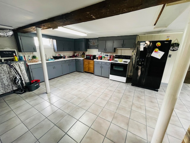 kitchen featuring black appliances, light tile patterned floors, and sink