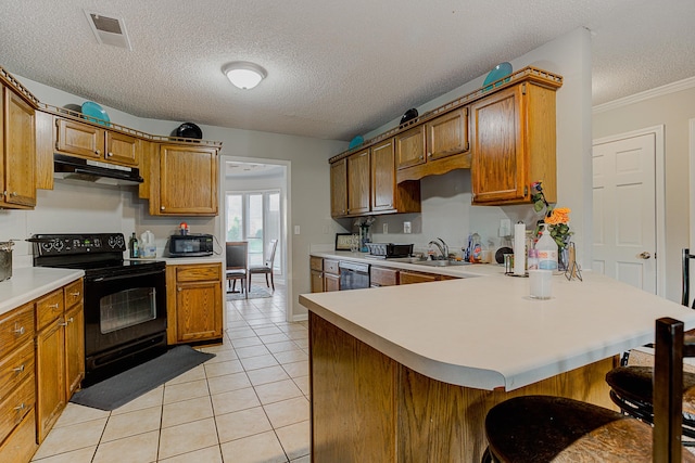 kitchen with a textured ceiling, black appliances, a kitchen bar, kitchen peninsula, and light tile patterned floors