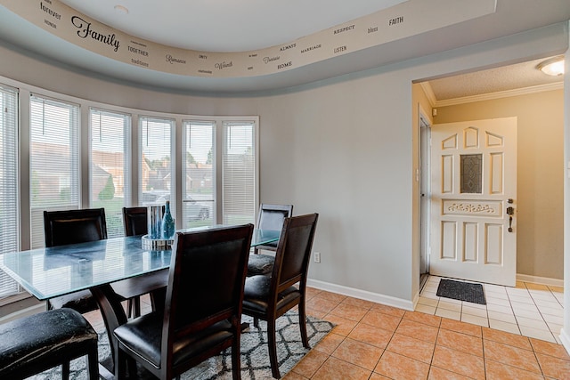 dining area with light tile patterned floors and ornamental molding