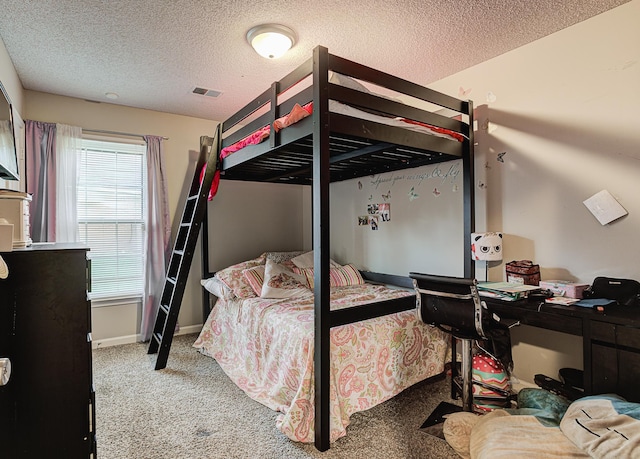 carpeted bedroom featuring a textured ceiling