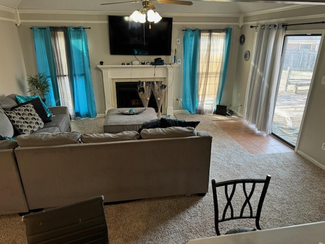 carpeted living room featuring ceiling fan and ornamental molding