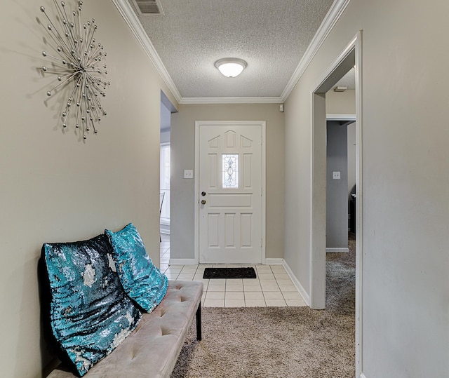 tiled entryway featuring a textured ceiling and ornamental molding