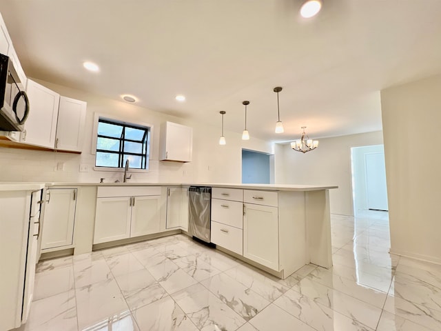 kitchen with tasteful backsplash, kitchen peninsula, hanging light fixtures, white cabinetry, and a chandelier