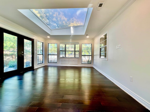 interior space with french doors, dark hardwood / wood-style floors, lofted ceiling with skylight, and crown molding