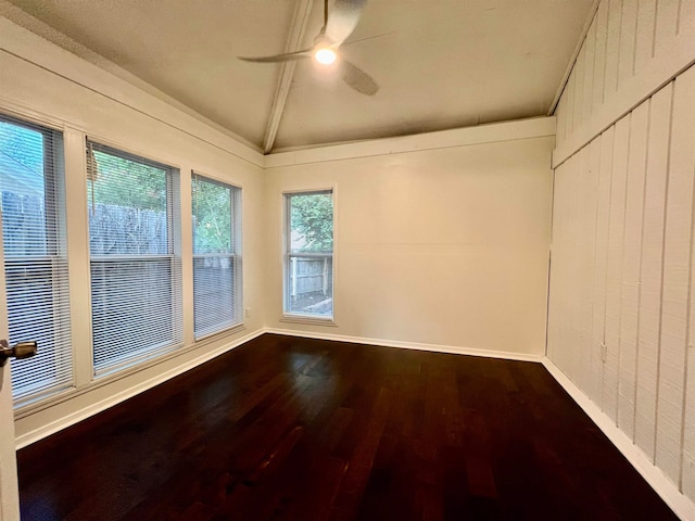 unfurnished room featuring hardwood / wood-style floors, a healthy amount of sunlight, ceiling fan, and vaulted ceiling