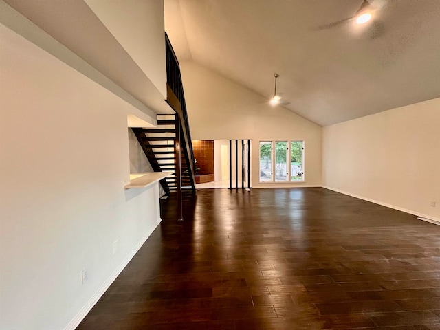 unfurnished living room featuring high vaulted ceiling and dark hardwood / wood-style floors