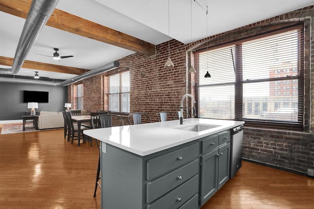 kitchen with a healthy amount of sunlight, a kitchen bar, brick wall, and decorative light fixtures