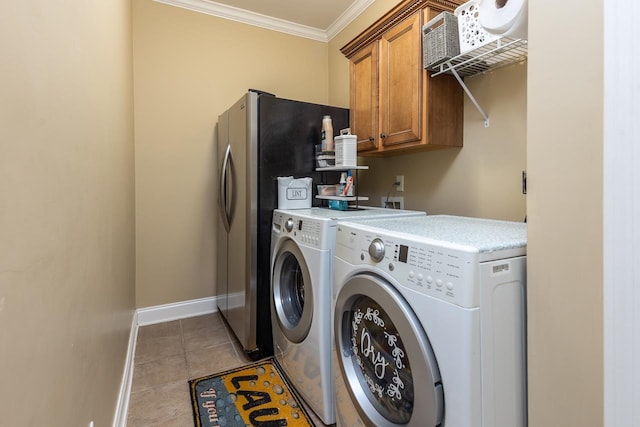 clothes washing area with washing machine and clothes dryer, ornamental molding, cabinets, and light tile patterned floors