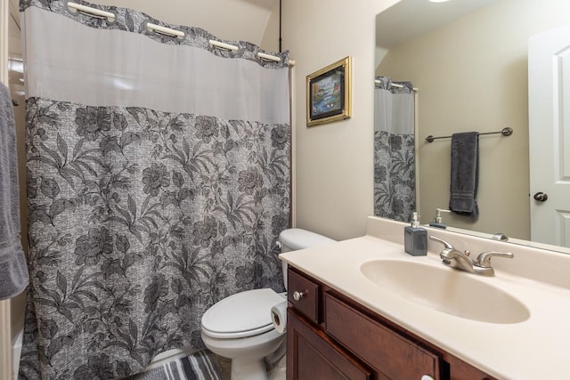 bathroom featuring vanity, toilet, and a shower with shower curtain