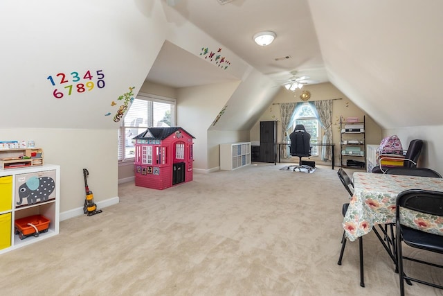 rec room with carpet floors, a healthy amount of sunlight, vaulted ceiling, and ceiling fan