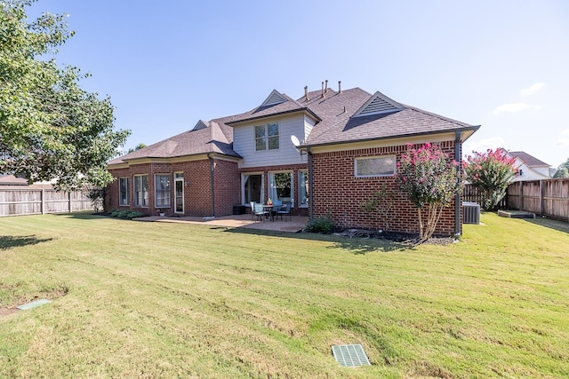 back of property featuring a lawn, central AC, and a patio area