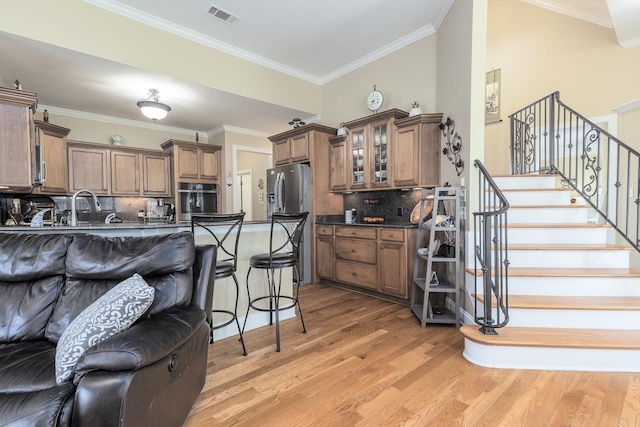 interior space with light hardwood / wood-style flooring and ornamental molding