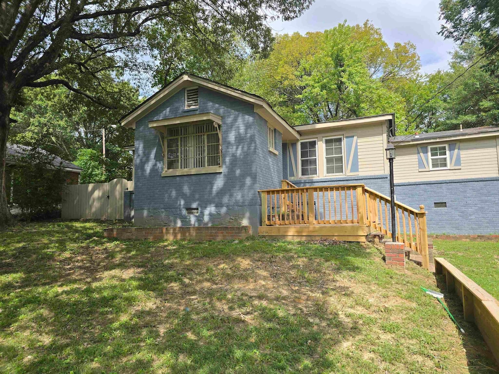 view of front of house with a front lawn and a deck