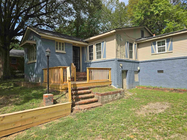 rear view of house featuring a yard and a deck