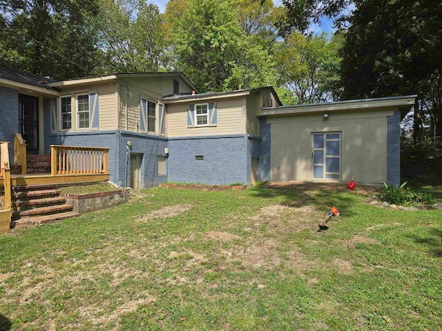 back of house with a lawn and a deck