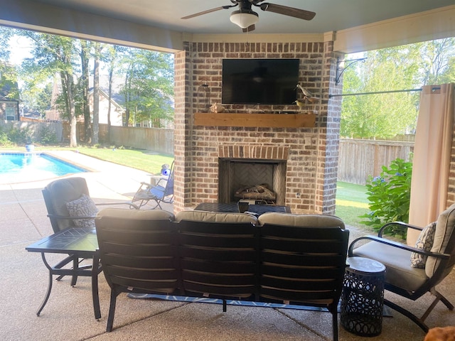 view of patio with ceiling fan, a fenced in pool, and an outdoor brick fireplace