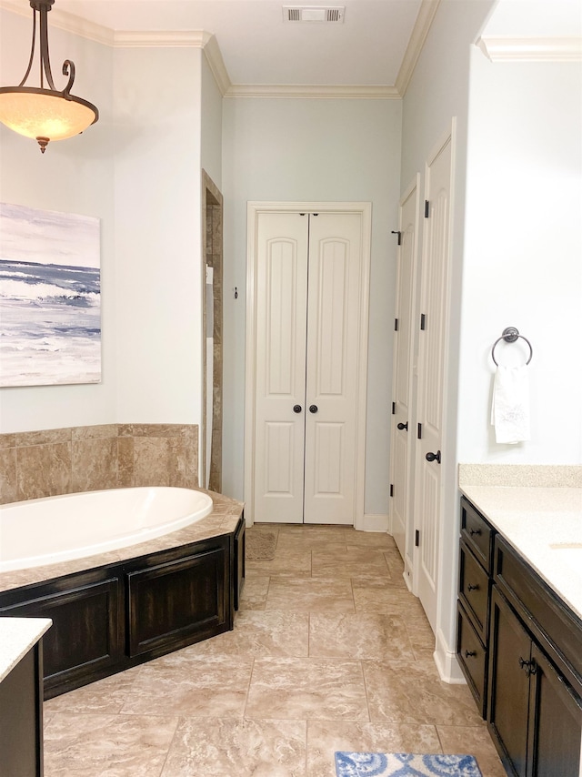 bathroom with vanity, a bathing tub, and ornamental molding