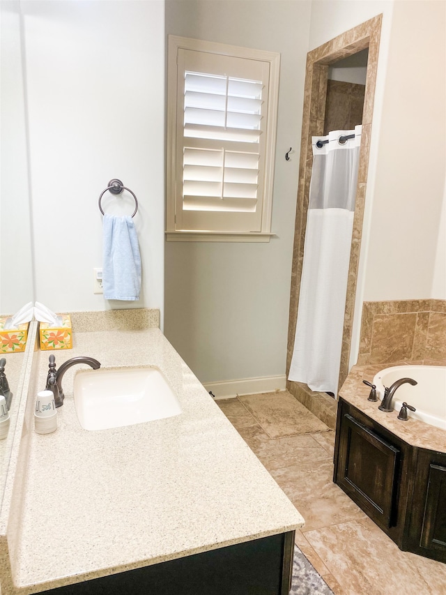 bathroom with vanity and independent shower and bath