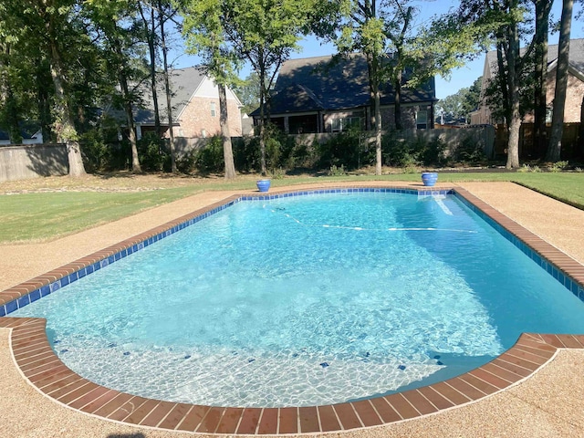 view of pool featuring a yard