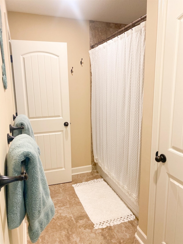 bathroom with tile patterned floors and a shower with shower curtain