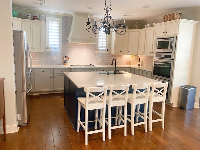 kitchen with plenty of natural light, an island with sink, appliances with stainless steel finishes, and sink