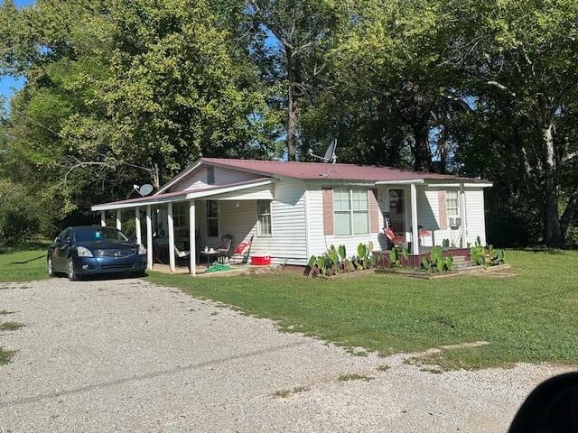 view of front of property with a carport and a front lawn