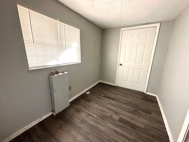 interior space with dark hardwood / wood-style flooring and a textured ceiling