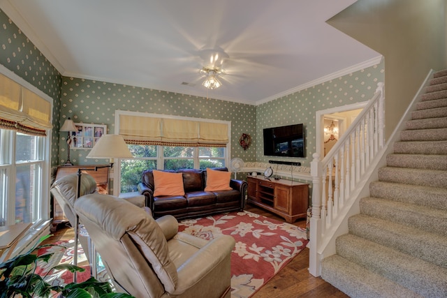 living room featuring wood-type flooring, crown molding, and a chandelier