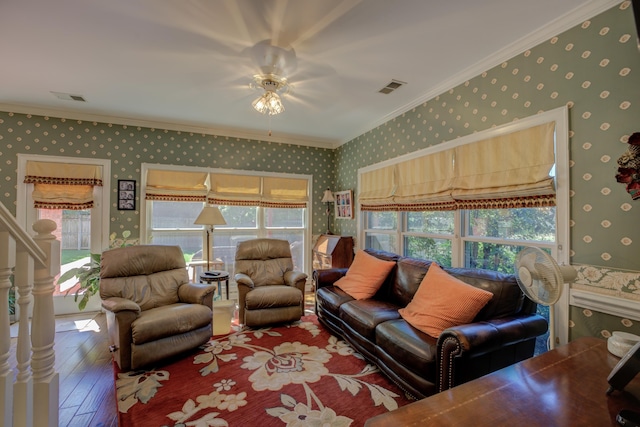 living room with ornamental molding and hardwood / wood-style flooring