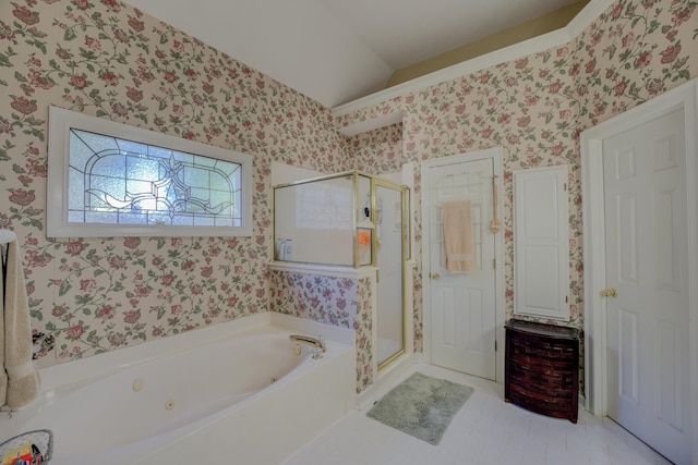 bathroom with independent shower and bath, vaulted ceiling, and tile patterned floors