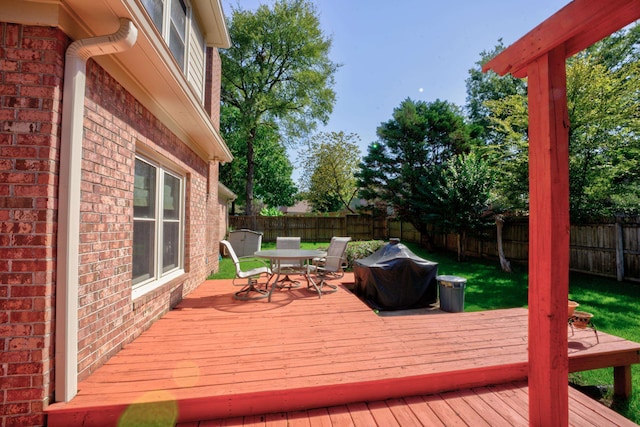 wooden deck featuring a grill