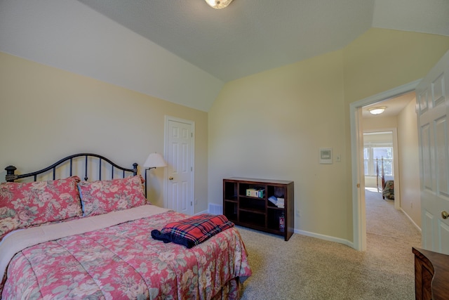 carpeted bedroom featuring lofted ceiling