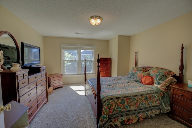 carpeted bedroom with a textured ceiling